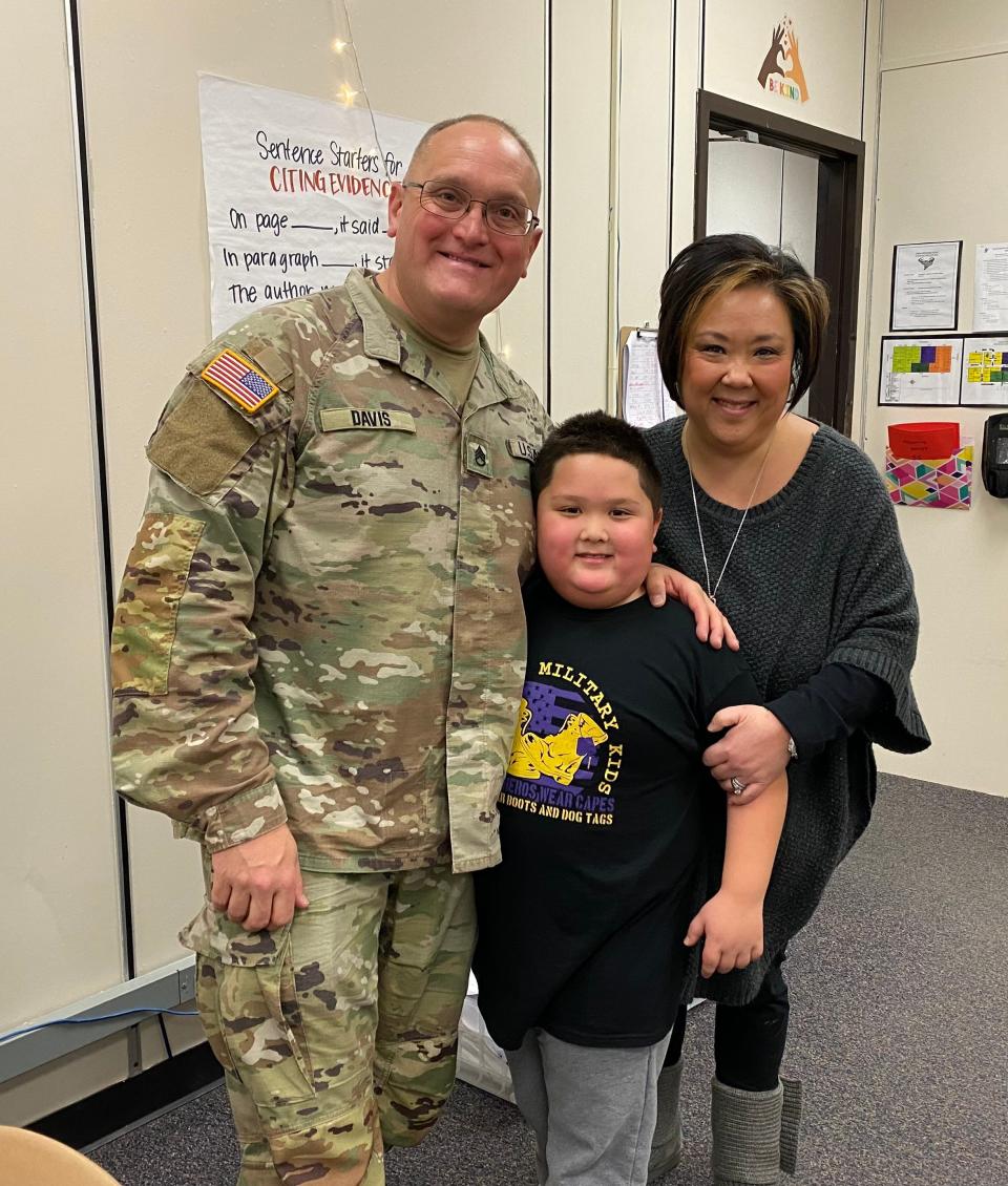 George Davis poses with son Park and wife Stacy after returning from a 10-month deployment.