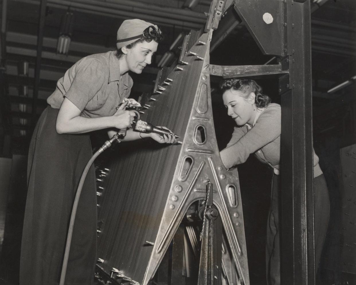 At the Ford Willow Run bomber plant riveter Thelma Ross (left) and her partner Ann Sierminski (right) build a B24 bomber in December of 1942. The plant, like hundreds of war factories across the country, employed many women in manufacturing jobs.