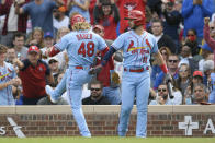 St. Louis Cardinals' Harrison Bader (48) celebrates with teammate Paul DeJong (11) after hitting a solo home run during the second inning of a baseball game against the Chicago Cubs Saturday, Sept. 25, 2021, in Chicago. (AP Photo/Paul Beaty)