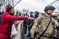 A protester points out to a National Guardsman while protesting the fatal shooting by police of Daunte Wright at a rally at the Brooklyn Center Police Department in Brooklyn Center, Minn., Monday, April 12, 2021. (Richard Tsong-Taatarii/Star Tribune via AP)