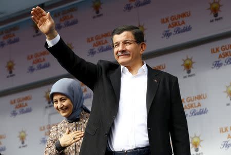 Turkish Prime Minister Ahmet Davutoglu, accompanied by his wife Sare Davutoglu, greets his supporters during an election rally of his AK Party in Ankara, Turkey, October 31, 2015. REUTERS/Umit Bektas