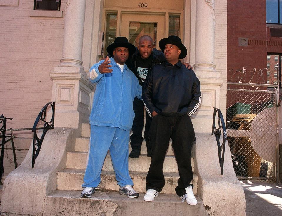 Rap trio Run D.M.C. poses on a New York City stoop in 2001. From left are Jam Master Jay (Jason Mizell), DMC (Darryl McDaniels), and DJ Run (Joseph Simmons). The hip-hop pioneers will be headlining a concert in New York in August 2023 to celebrate the 50th anniversary of the musical genre.