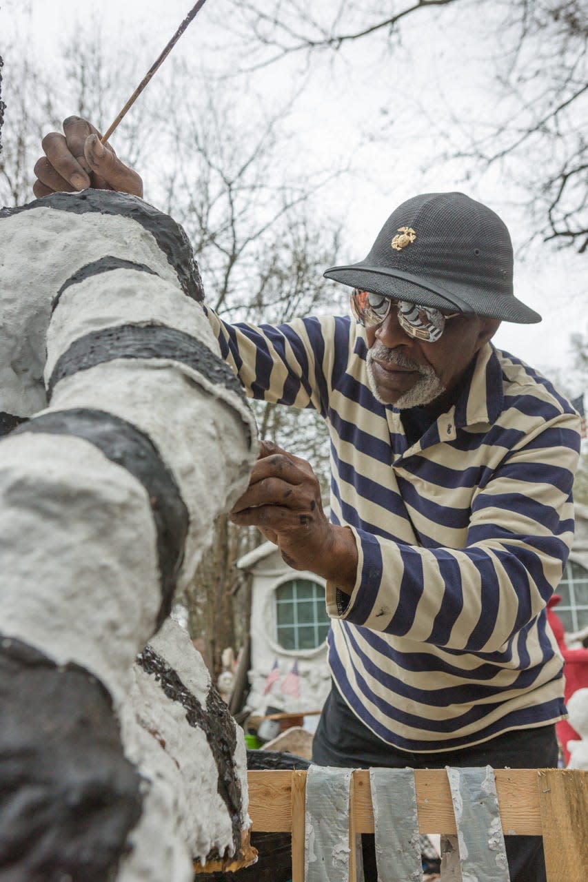 Dr. Charles Smith works on a sculpture at his home in Hammond. La.