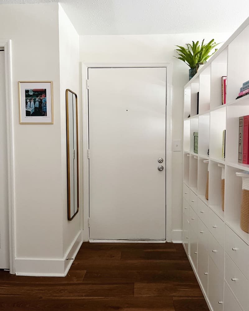 White entrance area with high white open shelves