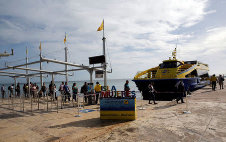 People are about to board a tourist boat with route to Isla Mujeres, after Tropical Storm Nate in Cancun, Mexico October 7, 2017. REUTERS/Henry Romero