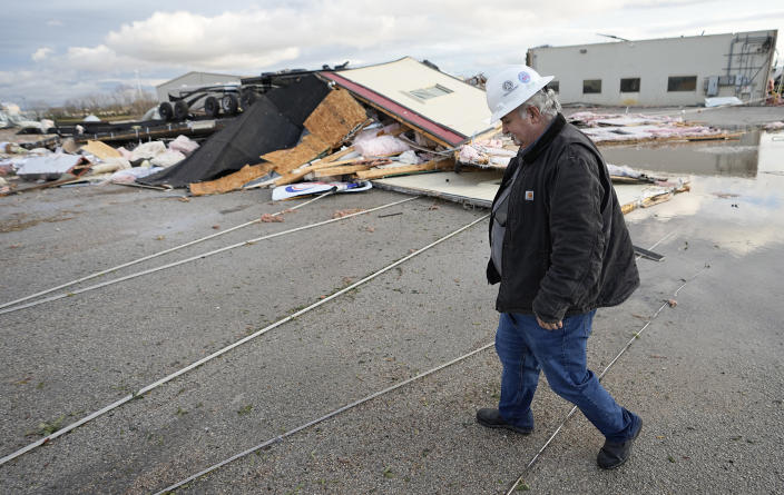 Johnny Graham walks past his storm-damaged office on Tuesday, Jan. 24, 2023, in Pasadena, Texas. A powerful storm system took aim at the Gulf Coast Tuesday, spawning tornados that caused damage east of Houston. (AP Photo/David J. Phillip)