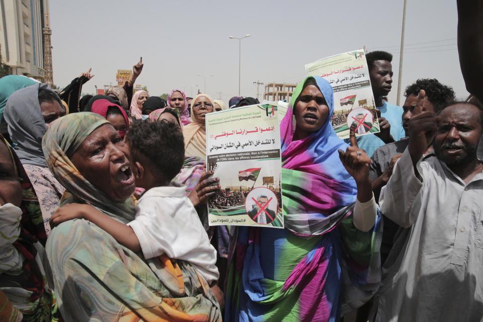 Dozens of people gather in front of the office of the United Nations Integrated Transition Assistance Mission in Sudan (UNITAMS) in support of Sudan’s military leaders, in Khartoum, Sudan, Wednesday, June 1, 2022. Their demonstration comes after Sudan’s top general, who took power in a coup last year, threatened in April to expel the U.N. envoy to the country, accusing him of interference in the country’s affairs. (AP Photo/Marwan Ali)