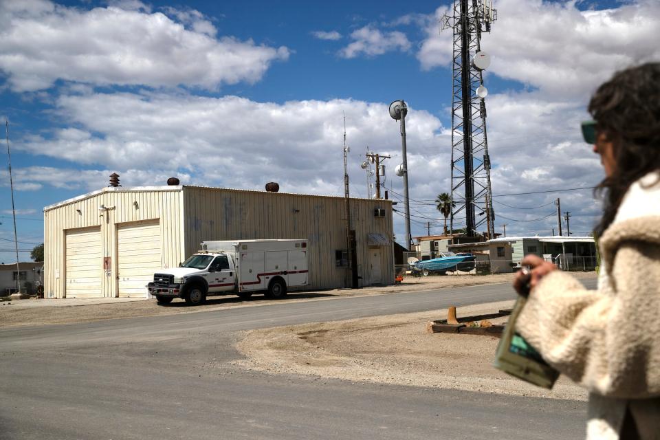 Photographer Brenda Ann Kenneally walks towards the vacant fire house in Bombay Beach, Calif., on March 19, 2024. The Bombay Beach Fashion Show will take place inside the venue this Saturday.