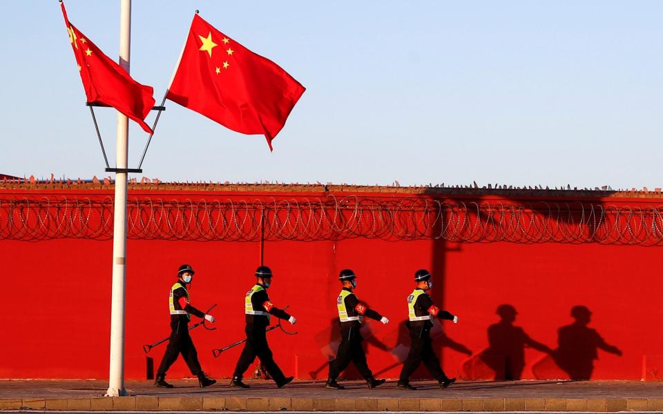 Police patrol the perimeter of the Capital International Airport in Beijing  - Thomas Peter/Reuters