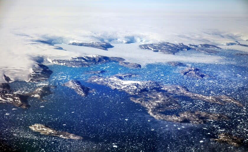 FILE - Icebergs float in a fjord after calving off from glaciers on the Greenland ice sheet in southeastern Greenland, Aug. 3, 2017. Climate change is going to get worse, but as gloomy as the latest scientific reports are, including today's from the United Nations, scientist after scientist stress that curbing global warming is not hopeless. The science says it is not game over for planet Earth or humanity. Action can prevent some of the worst if done soon, they say. (AP Photo/David Goldman, File)