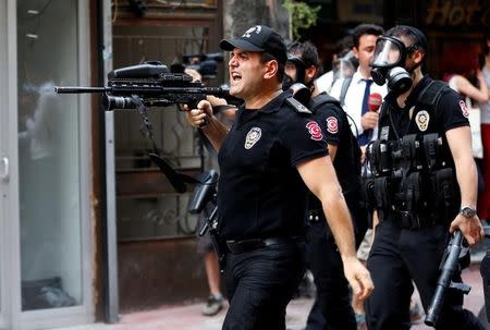 Riot police use rubber pellets to disperse LGBT rights activists as they try to gather for a pride parade, which was banned by the governorship, in Istanbul, Turkey, June 26, 2016. REUTERS/Murad Sezer/Files