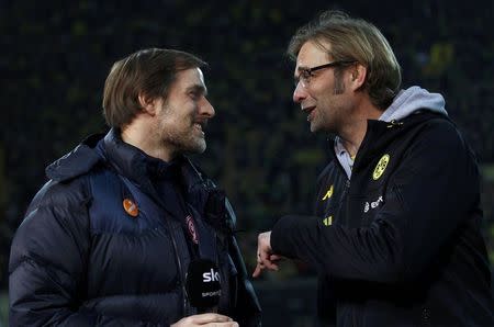 Borussia Dortmund coach Juergen Klopp talks to Mainz 05 coach Thomas Tuchel (L) before the German first division Bundesliga soccer match in Dortmund in this March 3, 2012 file photo. REUTERS/Ina Fassbender/Files