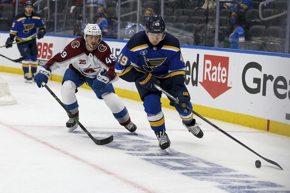 St. Louis Blues' Ivan Barbashev (49) controls the puck in front of Colorado Avalanche's Samuel Girard (49) during the second period in Game 3 of an NHL hockey Stanley Cup first-round playoff series Friday, May 21, 2021, in St. Louis. (AP Photo/Scott Kane)