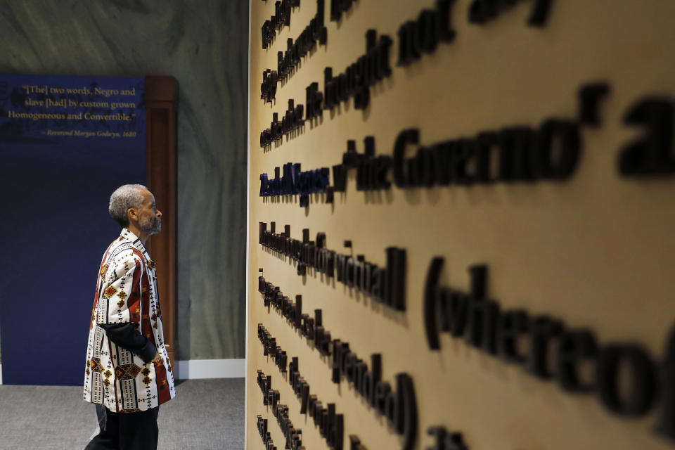 FILE - In this Aug. 24, 2019 file photo, Jerome Jones explores inside the Fort Monroe Visitor And Education Center during the First African Landing Commemorative Ceremony at Fort Monroe, Va. Officials observed the arrival of enslaved Africans 400 years earlier to what is now Virginia. Proposals in Arkansas, Iowa and Mississippi would prohibit schools from using a New York Times project that focused on slavery's legacy. (Jonathon Gruenke/The Daily Press via AP)