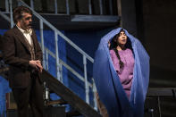 Karin Mushegain, right, who portrays Mariam, emerges from a burqa given to her by John Moore, who portrays Rasheed, during a dress rehearsal for the opera "A Thousand Splendid Suns," in Seattle, on Wednesday, Feb. 22, 2023. Kabul-born author Khaled Hosseini, the book’s author who lives in California, had hoped the story would become a relic of the past, maybe a "cautionary tale.” But instead, he said, “what’s going on with women today is a cruel deja vu.” (AP Photo/Stephen Brashear)