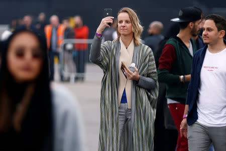 A tourist takes a photo as she attends a Formula E race in Riyadh, Saudi Arabia December 15, 2018. REUTERS/Faisal Al Nasser