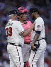 Atlanta Braves pitcher Huascar Ynoa, right, speaks with pitching coach Rick Kranitz (39) and catcher William Contreras during the first inning of a baseball game against the Philadelphia Phillies on Sunday, May 9, 2021, in Atlanta. (AP Photo/Ben Margot)