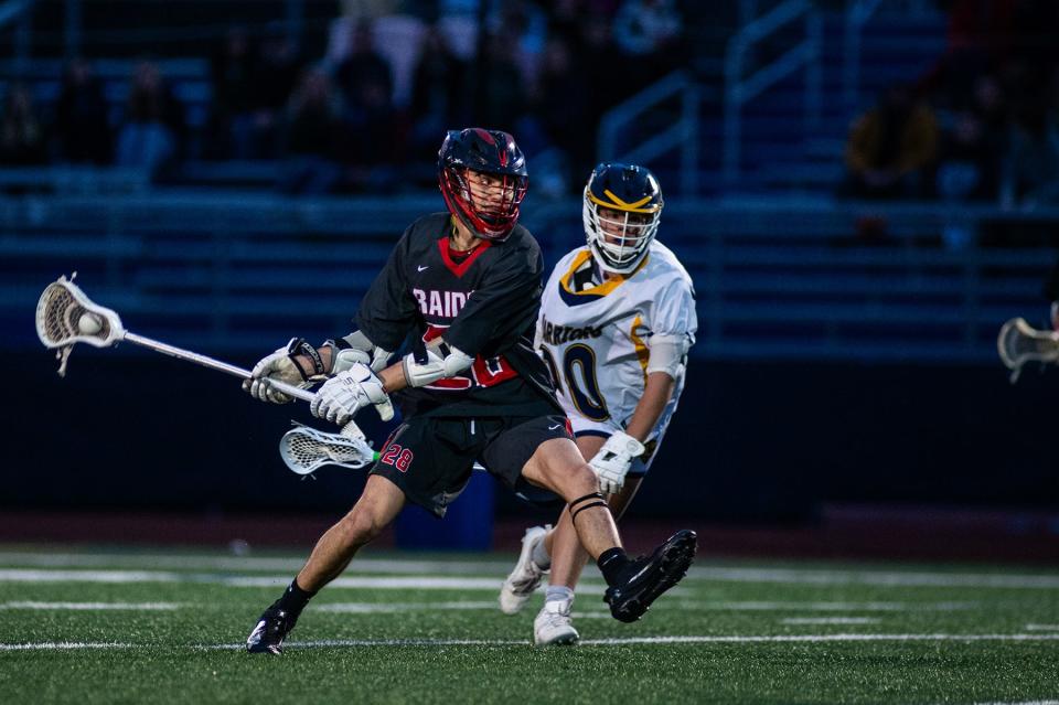 Red Hook's John Macri, left, takes a shot against Lourdes during an April 19, 2024 boys lacrosse game.