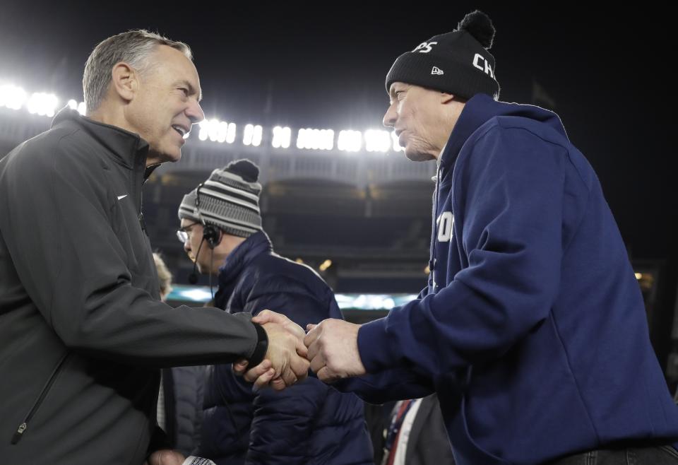 Michigan State head coach Mark Dantonio, left, shakes hands with Pro Football Hall of Fame quarterback Jim Kelly, right, during the second half of the Pinstripe Bowl NCAA football game Friday, Dec. 27, 2019, in New York. (AP Photo/Frank Franklin II)