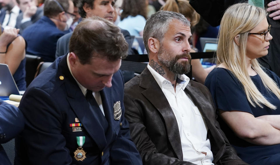 Washington Metropolitan Police Department officer Daniel Hodges, left, and former Washington Metropolitan Police Department officer Michael Fanone, center, listen as the House select committee investigating the Jan. 6 attack on the U.S. Capitol holds its first public hearing to reveal the findings of a year-long investigation, at the Capitol in Washington, Thursday, June 9, 2022. (AP Photo/J. Scott Applewhite)