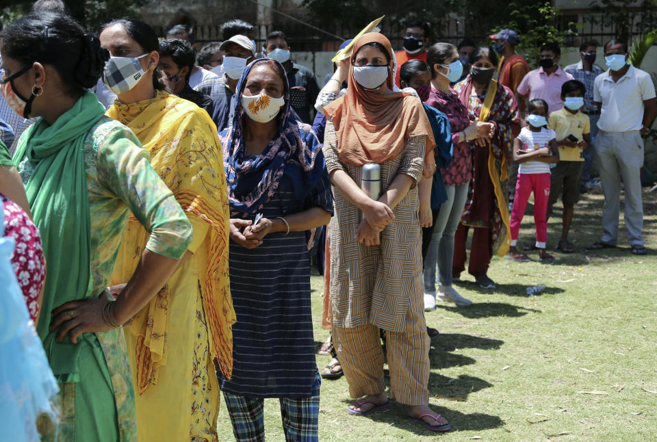 People line up to get tested for COVID-19 in Jammu, India, Monday, May 24, 2021. India crossed another grim milestone Monday of more than 300,000 people lost to the coronavirus as a devastating surge of infections appeared to be easing in big cities but was swamping the poorer countryside. (AP Photo/Channi Anand)