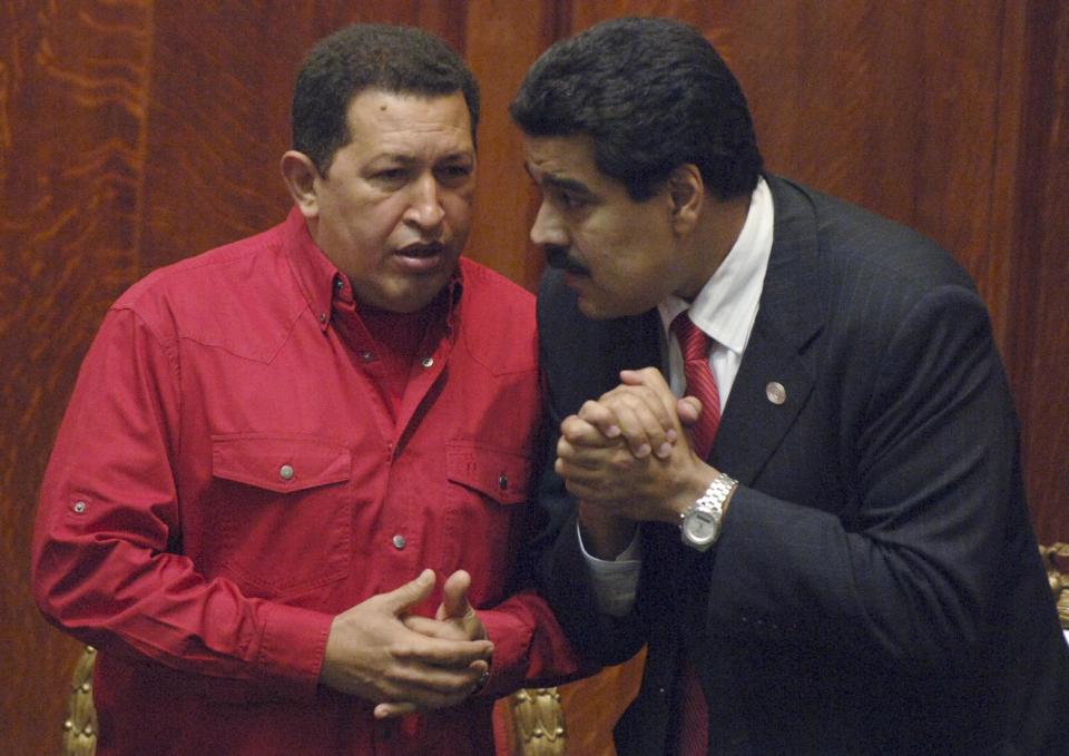 FILE - In this Dec. 18, 2007 file photo Venezuela's President Hugo Chavez, left, talks to his Foreign Minister Nicolas Maduro at the University of Uruguay in Montevideo, Uruguay. President Hugo Chavez on Wednesday, Oct. 10, 2012, named Nicolas Maduro as his new vice president. Maduro, a former National Assembly member, has headed the foreign ministry since 2006, and is seen as one of the administration's hard-liners. (AP Photo/Matilde Campodonico, File)