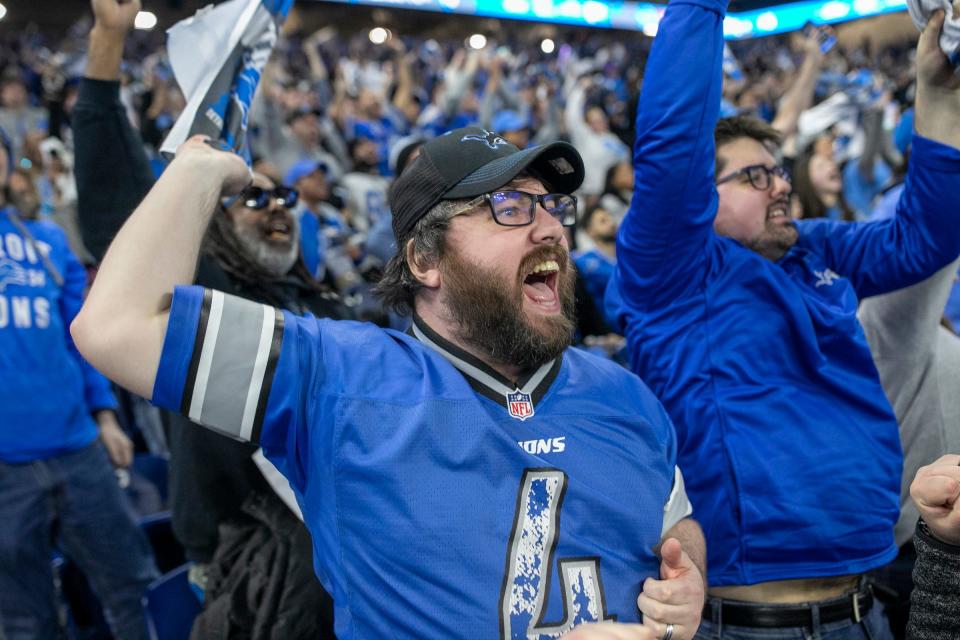 Robert Buchanan, 32, of New Haven, waves his towel after Detroit Lions LB Malcolm Rodriquez makes an interception during the Detroit Lions NFC Championship watch party at Ford Field in Detroit on Sunday, Jan. 28, 2024.