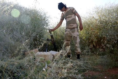 A Tajammu al-Ezza brigade fighter prepares to fire a mortar shell towards forces loyal to Syria's president Bashar Al-Assad located on Al-Zlakiet checkpoint in Hama countryside May 6, 2015. REUTERS/Mohamad Bayoush