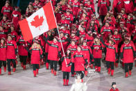 <p>Figure Skater Tessa Virtue leads Canada’s national team who wear crimson red parkas with a motif of the maple leaf emblazoned on the back during the opening ceremony of the 2018 PyeongChang Games. (Photo by Roland Harrison/Action Plus via Getty Images) </p>