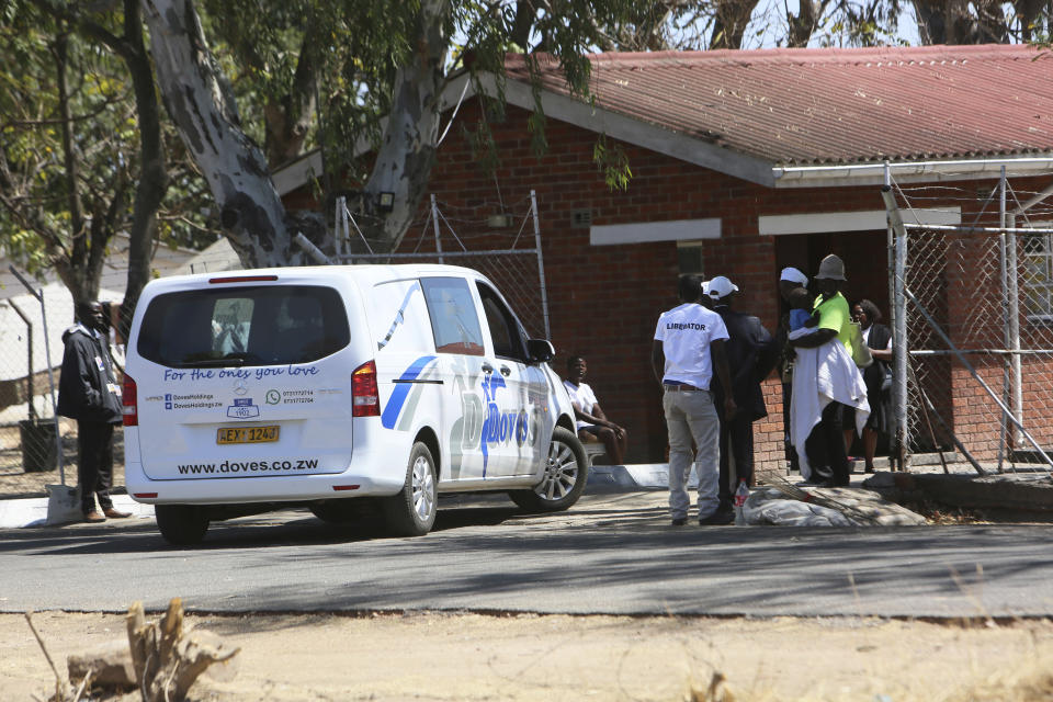 A van from a funeral parlor enters former President Robert Mugabe's rural home in Zvimba, about 100 kilometers north west of the capital Harare, Saturday, Sept. 28, 2019. According to a family spokesperson Mugabe is expected to be buried at the residence after weeks of drama mystery and contention over his burial place. (AP Photo/Tsvangirayi Mukwazhi)