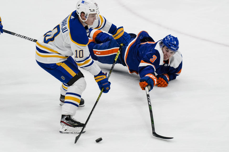 New York Islanders' Adam Pelech (3) fights for control of the puck with Buffalo Sabres' Henri Jokiharju (10) during the second period of an NHL hockey game Thursday, March 4, 2021, in Uniondale, N.Y. (AP Photo/Frank Franklin II)