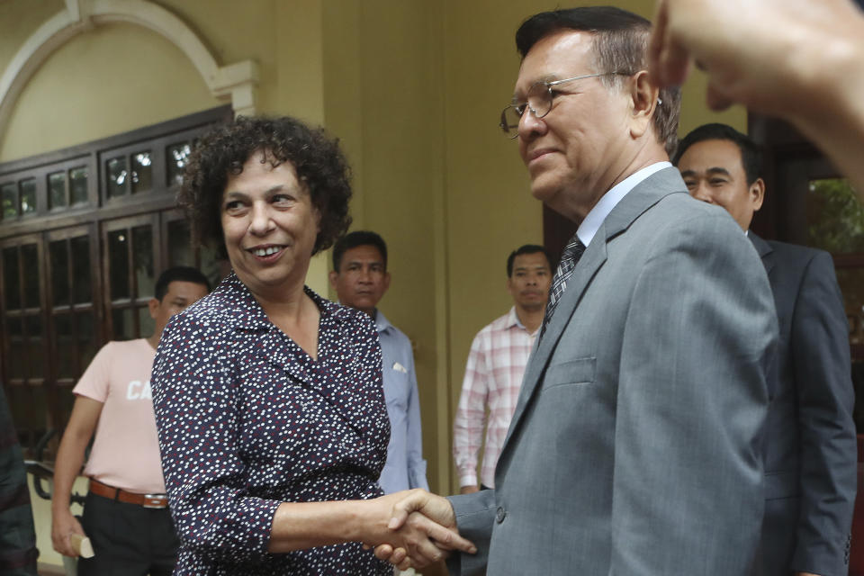 E.U. Ambassador to Cambodia Carmen Moreno, left, shakes hands with the banned Cambodia National Rescue Party's President Kem Sokha before a meeting at his house in Phnom Penh, Cambodia, Wednesday, Nov. 13, 2019. Kem Sokha was freed Sunday by court order after more than two years in detention without trial. (AP Photo/Heng Sinith)