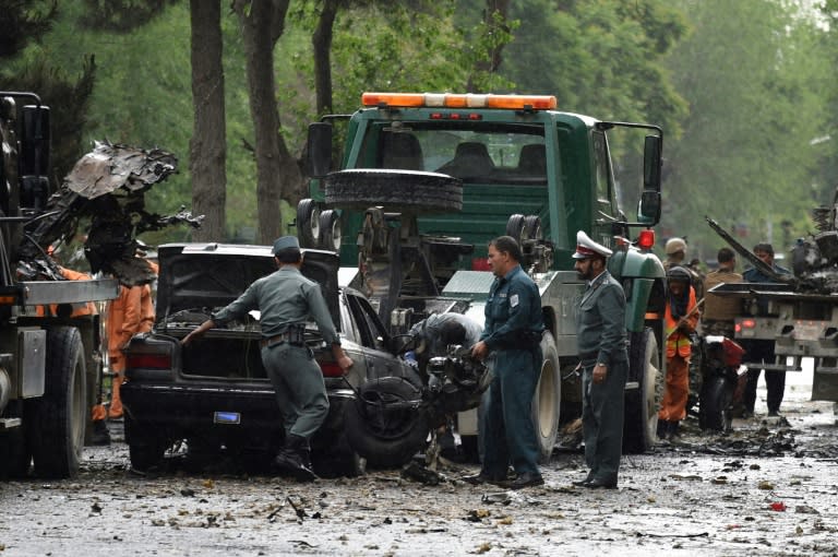 Afghan security personnel investigate the site of a suicide attack that targeted a foreign forces convoy near the US embassy in Kabul on May 3, 2017