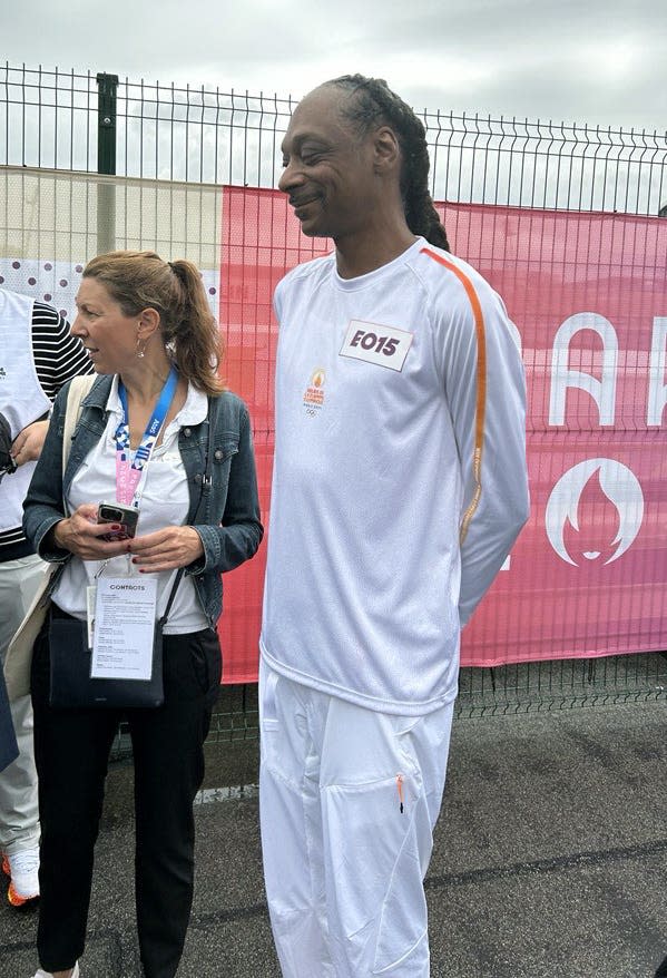 Crowds cheer as Snoop Dogg carries Olympic torch for Paris 2024 Games