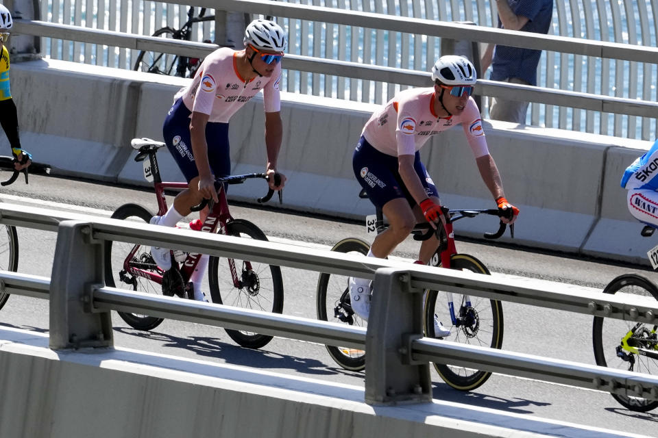 Mathieu van der Poel, left, of the Netherlands follows compatriot Pascal Eenkhoorn across the Sea Cliff Bridge during the elite men's road race at the world road cycling championships in Wollongong, Australia, Sunday, Sept. 25, 2022. (AP Photo/Rick Rycroft)