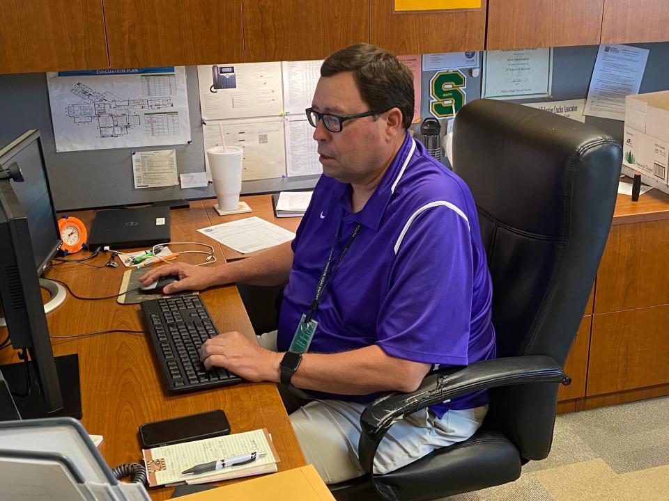 Salina South athletic director Ken Stonebraker works at his desk at South High School Monday, June 6, 2022. Stonebraker announced his retirement in May after 30 years at the school and 15 as the school's athletic director.