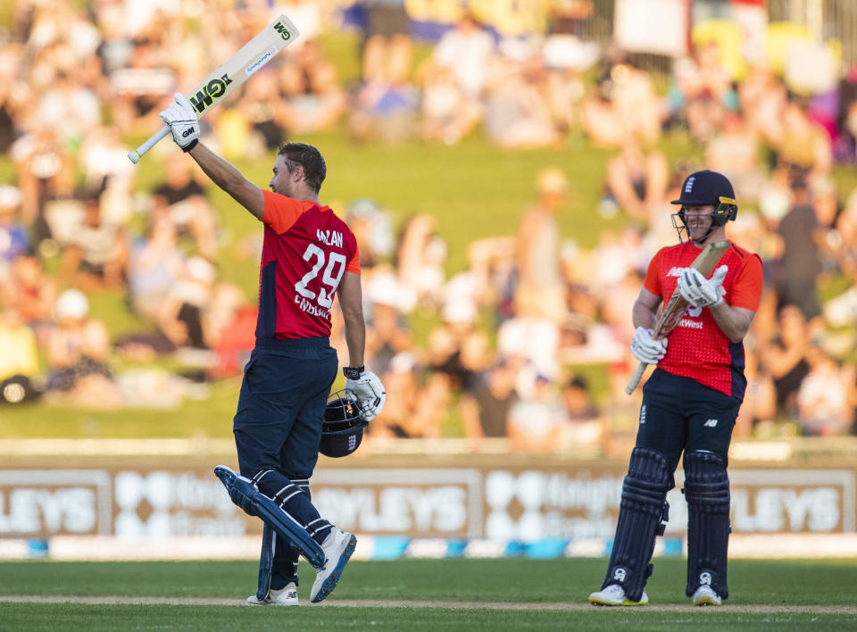 England's David Milan celebrates his century as England captain Eion Morgan applauds during the T20 cricket match between England and New Zealand in Napier, New Zealand, Friday, Nov. 8, 2019. (John Cowpland/Photosport via AP)