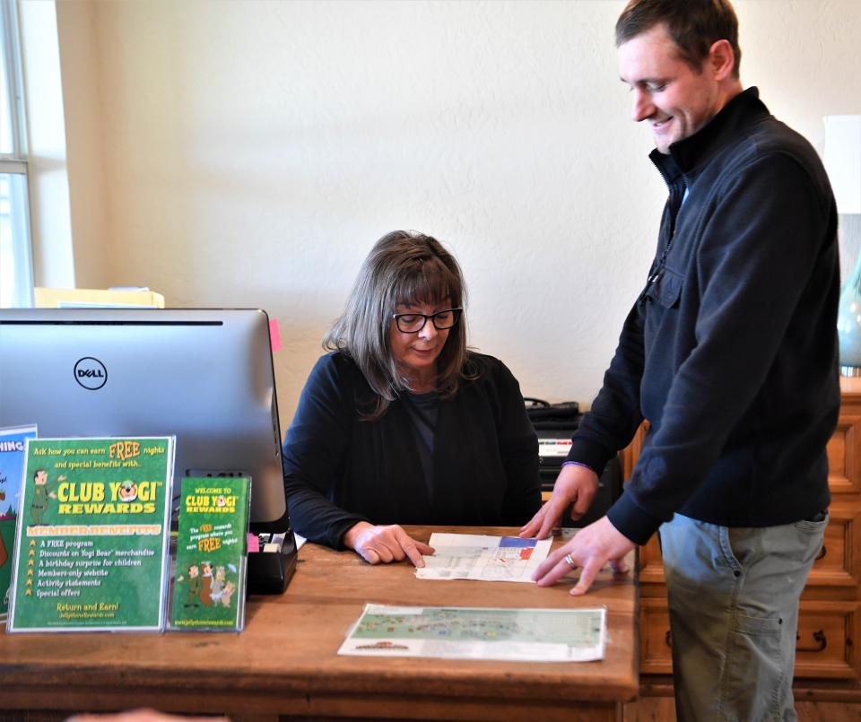 Yogi Bear's Jellystone Park's General Manager Zac Sharp (right) looks over important documents with Front Office Manager Paula Terry.