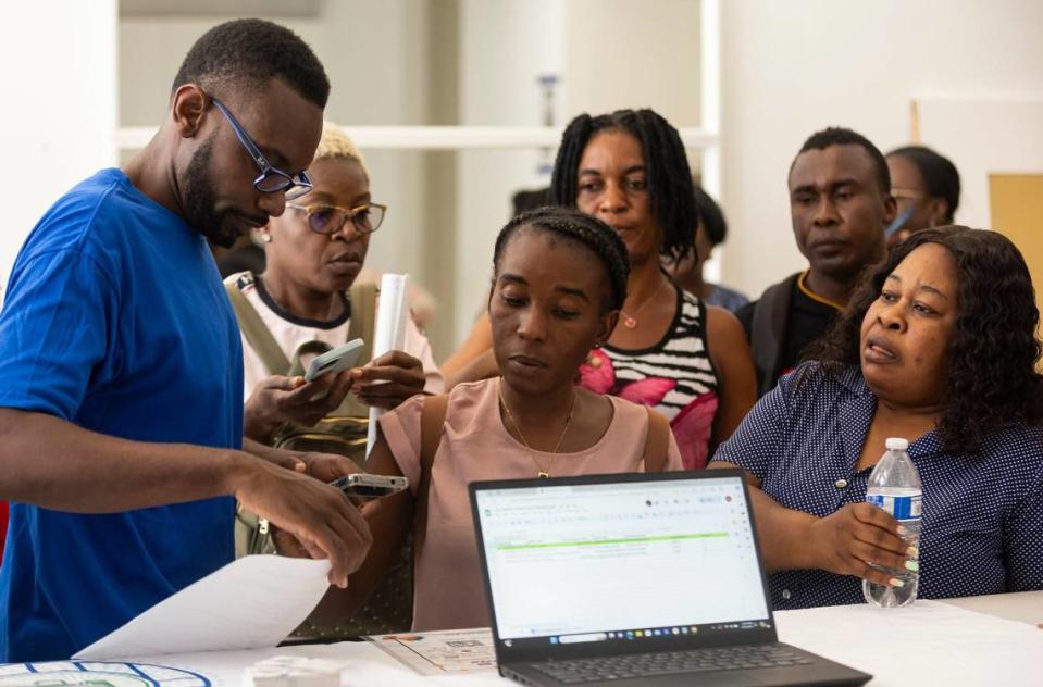 Sammy Lamy, the director of Jobs For Us, helps people register for a community resource fair at the Magic City Innovation District on Friday, May 31, 2024, in Miami, Fla. The fair aimed at helping recently arrived Haitians and other immigrants connect with health care providers and prospective employers.