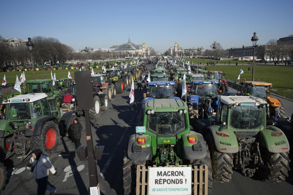 Tractors park in front of the Grand Palais museum on the Esplanade des Invalides,, Wednesday, Feb. 8, 2023 in Paris. French sugarbeet and other farmers disrupt Paris traffic with hundreds of tractors to protest an EU pesticide ban they say will devastate their livelihoods and industry. (AP Photo/Christophe Ena)