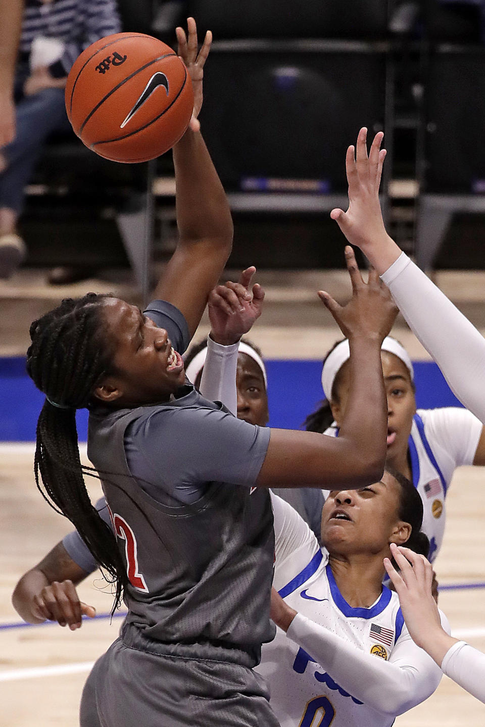 Louisville's Elizabeth Dixon, left, can't get off a shot with Pittsburgh's Jahsyni Knight (0) defending during the first half of the an NCAA college basketball game in Pittsburgh, Sunday, Feb. 23, 2020. (AP Photo/Gene J. Puskar)