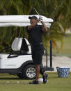 Tiger Woods watches his shot during a practice session at the Albany Golf Club, on the sidelines of day three of the Hero World Challenge Golf tour, in New Providence, Bahamas, Saturday, Dec. 4, 2021. (AP Photo/Fernando Llano)