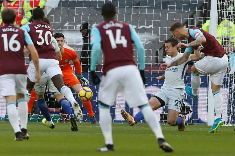 West Ham United's midfielder Marko Arnautovic (R) shoots past Chelsea's goalkeeper Thibaut Courtois (3rd L) to score