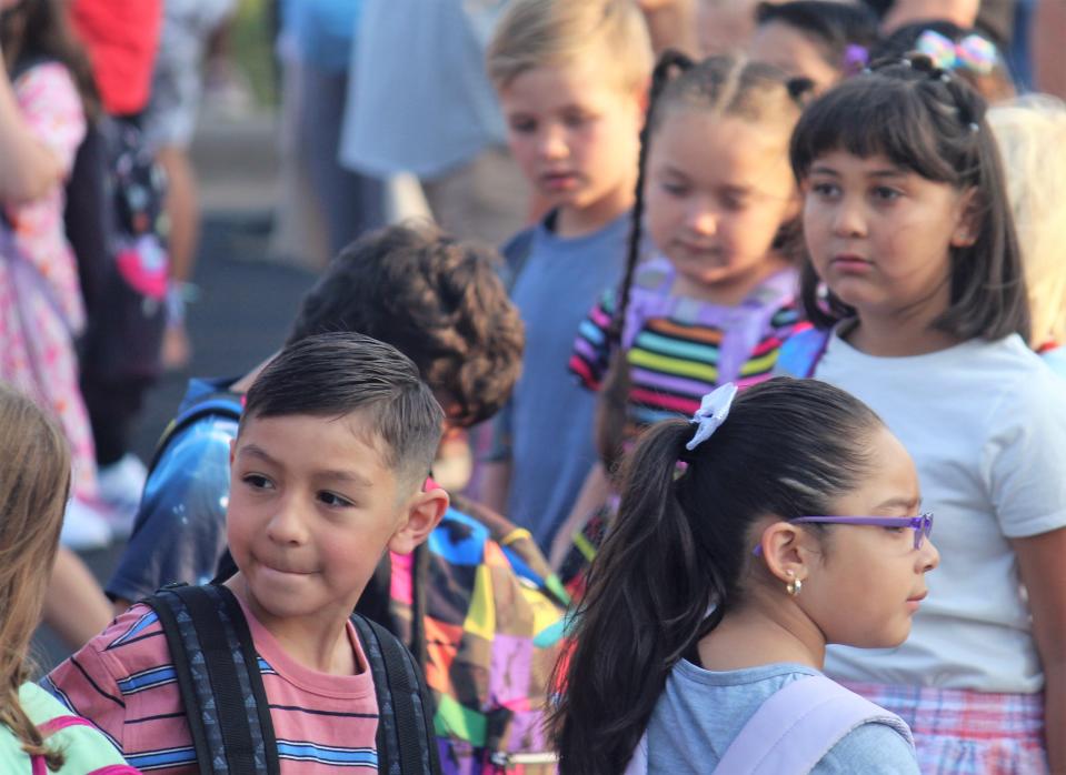Students wait for the first day of school to begin at Holland Language Academy in August 2023.