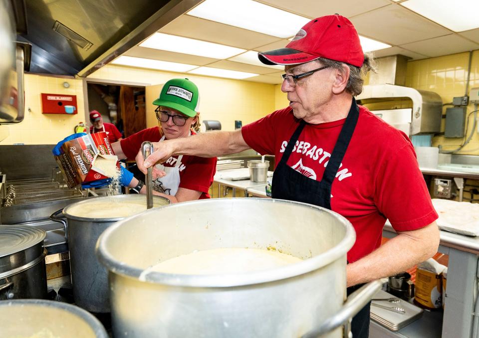 Liz Martin and Mark Krier prepare shrimp chowder for the St. Sebastian Parish fish fry on Friday, March 1. The church was expecting a large crowd because it was the only sit-down date during Lent.