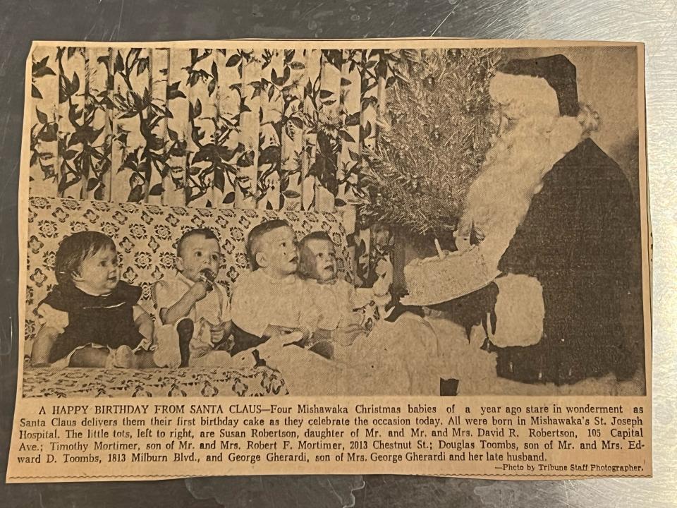 Four babies were born on Christmas Day 1959 at Mishawaka's St. Joseph Hospital. The four, Susan Robertson, left, Timothy Mortimer, Douglas Toombs and George Gherardi receive birthday wishes on their first birthday. Santa presents a cake to the gang. The photo was published in the South Bend Tribune.