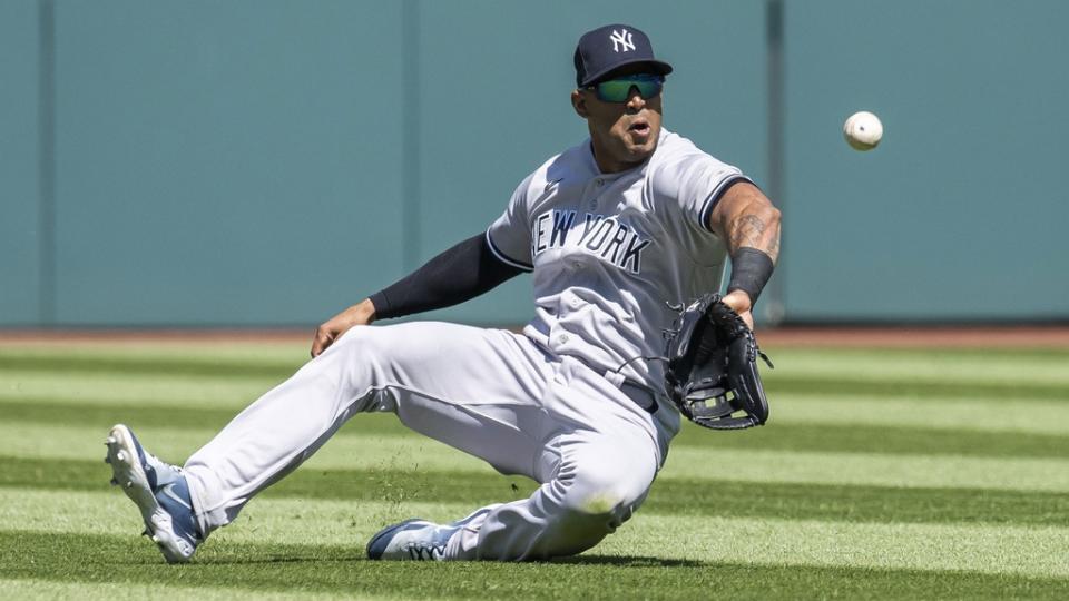 Apr 12, 2023; Cleveland, Ohio, USA; New York Yankees center fielder Aaron Hicks (31) makes a sliding attempt to catch a ball hit by Cleveland Guardians designated hitter Josh Naylor (not pictured) during the first inning at Progressive Field. Hicks was unable to make the catch.