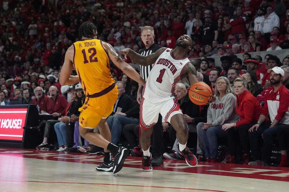 Houston's Jamal Shead (1) is fouled by Iowa State's Robert Jones (12) during the second half of an NCAA college basketball game Monday, Feb. 19, 2024, in Houston. Houston won 73-65. (AP Photo/David J. Phillip)