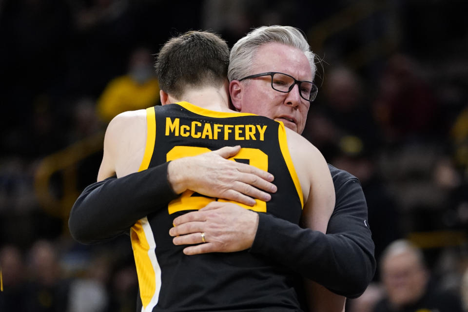 Iowa head coach Fran McCaffery gets a hug from his son Patrick at the end of an NCAA college basketball game against Iowa State, Thursday, Dec. 8, 2022, in Iowa City, Iowa. Iowa won 75-56. (AP Photo/Charlie Neibergall)