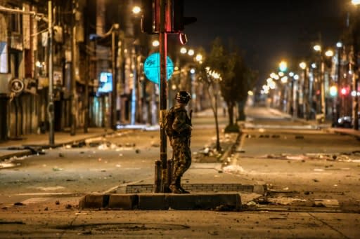 A Colombian soldier guards a street in Bogota's Patio Bonito neighborhood after November 2019 protests